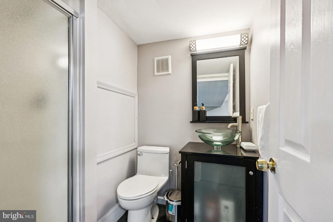 902 Rural Avenue Voorhees, NJ 08043 - Photo 23 of 25 a bathroom with a granite countertop sink toilet and mirror