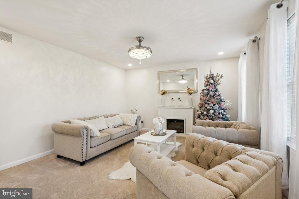 902 Rural Avenue Voorhees, NJ 08043 - Photo 3 of 25 a living room with furniture fireplace and a window