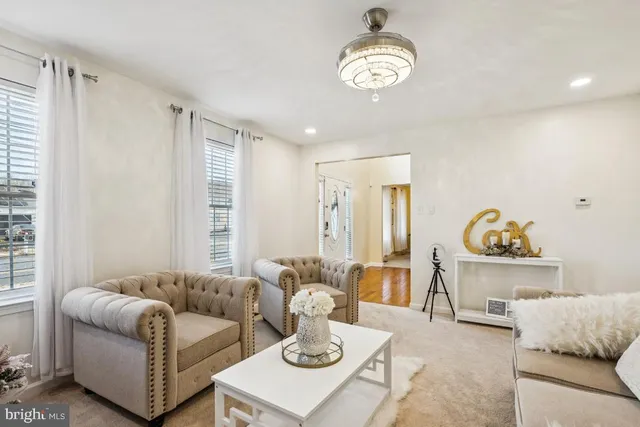 a view of a dining room with furniture a chandelier and window