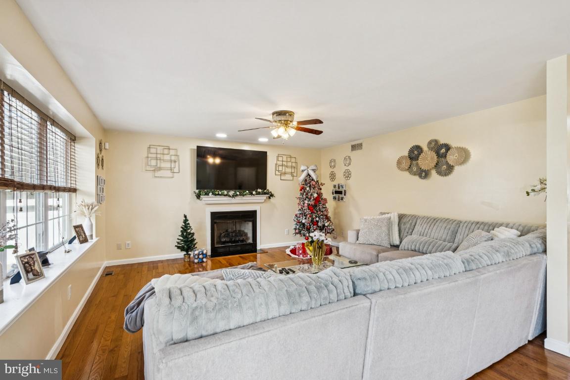 902 Rural Avenue Voorhees, NJ 08043 - Photo 6 of 25 a living room with furniture a flat screen tv and a fireplace