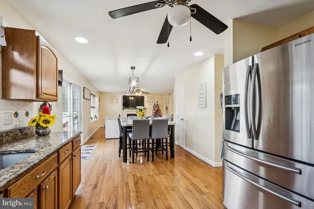 a kitchen with stainless steel appliances a stove a sink and a refrigerator