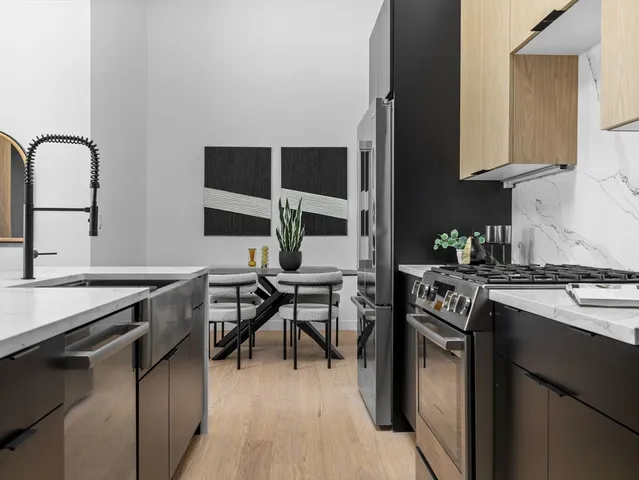 a kitchen with stainless steel appliances granite countertop a stove and a sink