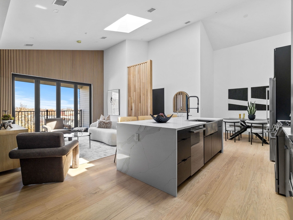 22 High Street, Unit 201 Boston, MA 02122 - Photo 3 of 6 a living room with furniture and a flat screen tv