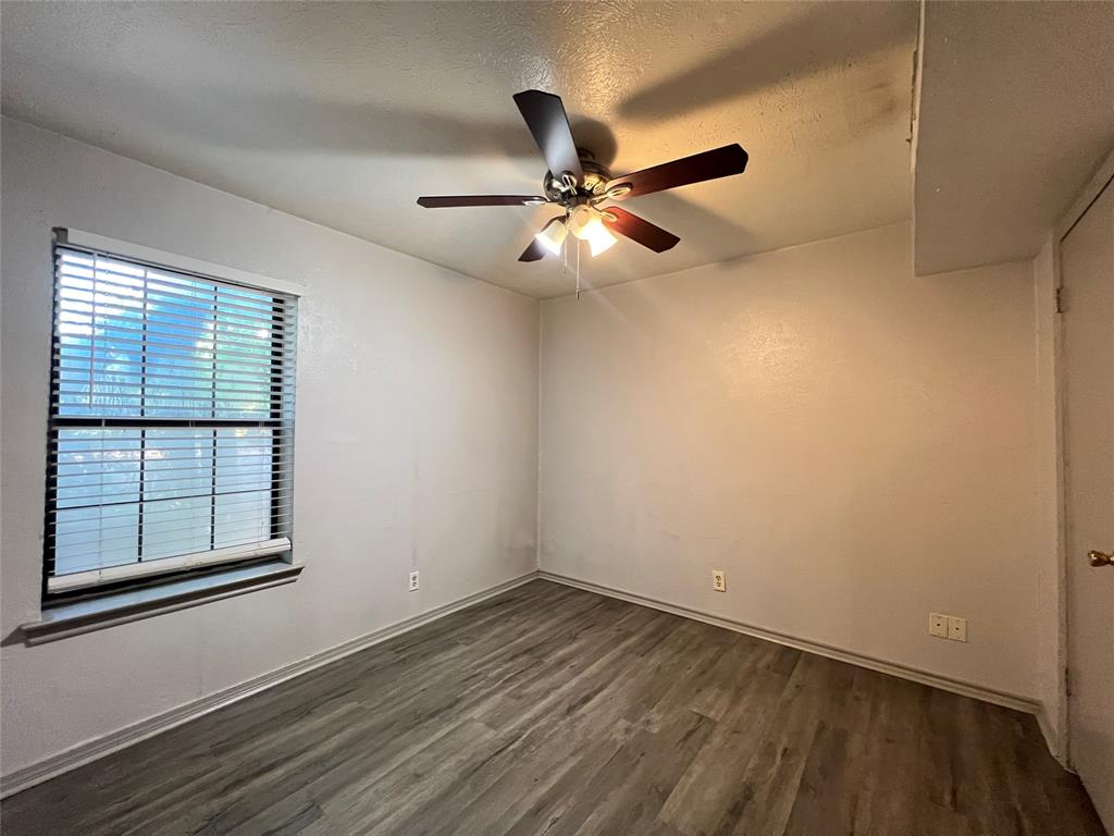 1108 North Elm Street, Unit 3 Denton, TX 76201 - Photo 13 of 15 a view of empty room with wooden floor and fan