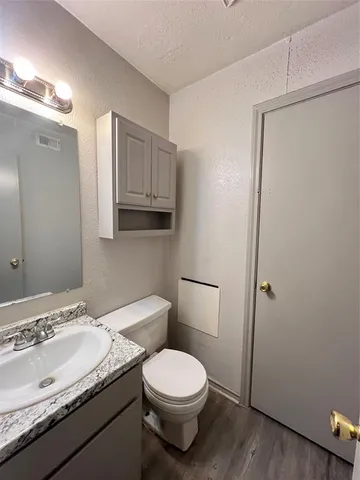 a bathroom with a granite countertop sink toilet and shower