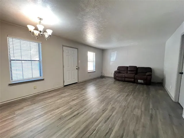 a view of a livingroom with wooden floor and a ceiling fan