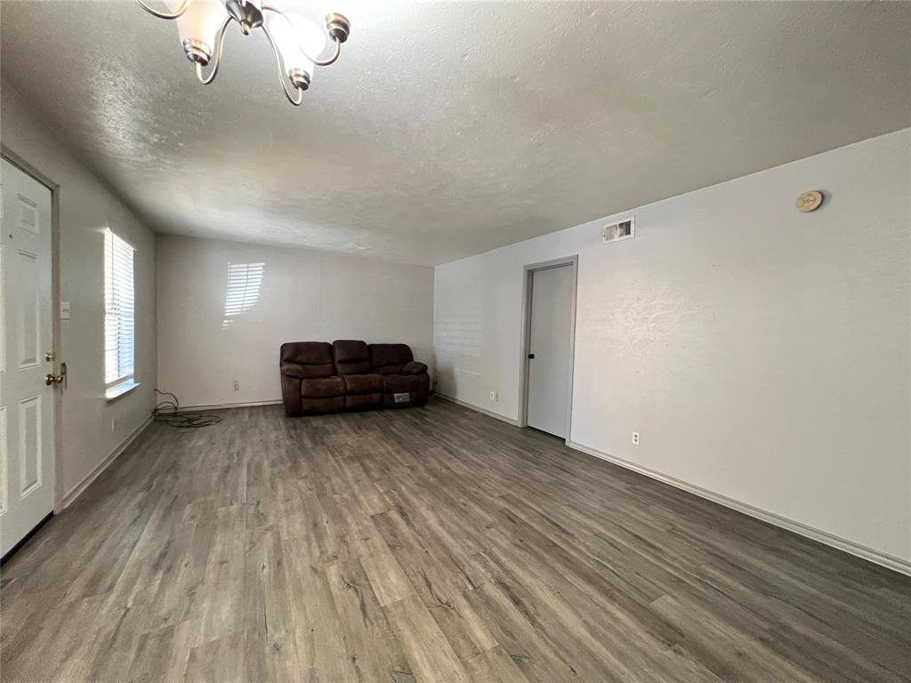 1108 North Elm Street, Unit 3 Denton, TX 76201 - Photo 4 of 15 a view of a livingroom with a chandelier