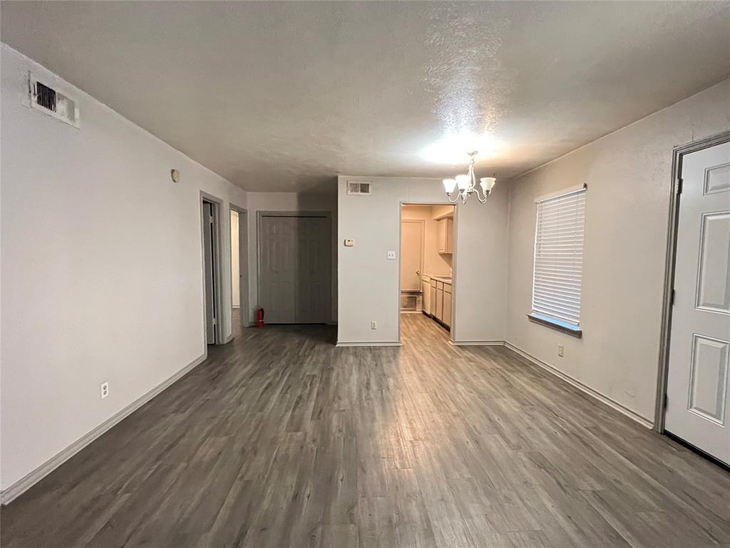 1108 North Elm Street, Unit 3 Denton, TX 76201 - Photo 7 of 15 a view of a room with wooden floor and a window