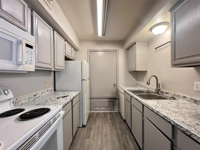 a kitchen with a sink stove and refrigerator