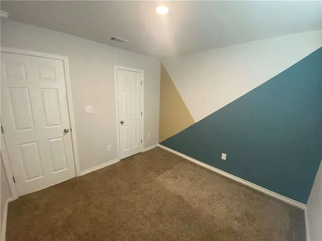 an empty room with windows and entrance