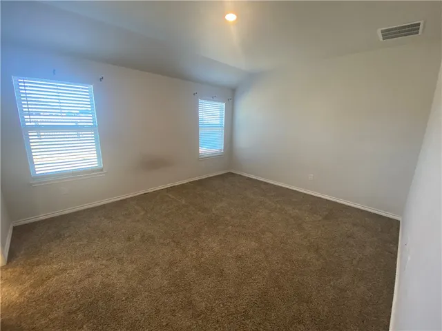 a bathroom with a granite countertop sink a mirror and a shower