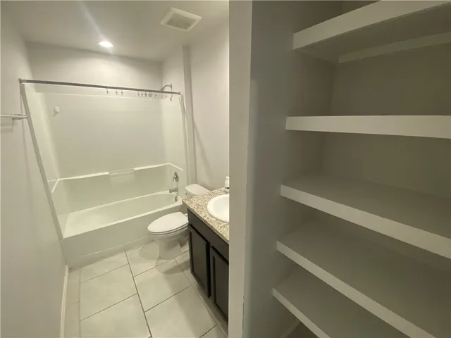 a bathroom with a toilet a sink and bathtub