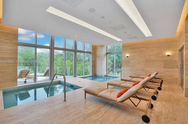 a dining room with furniture and a window