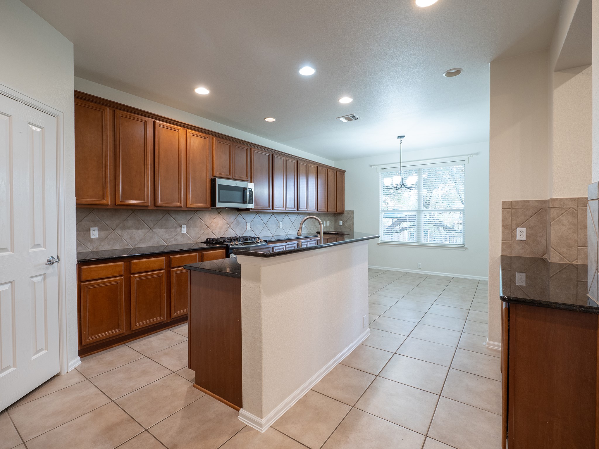 572 Big Meadow Road Austin, TX 78737 - Photo 4 of 32 Culinary delights await in this modern kitchen with ample cabinetry and a practical island.
