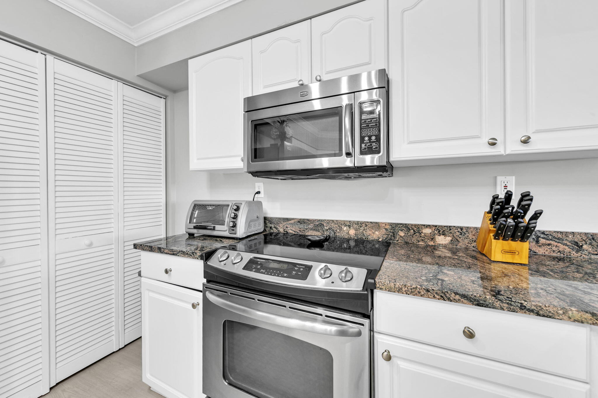 1044 Highway 98, Unit 101 Destin, FL 32541 - Photo 11 of 33 a kitchen with granite countertop a stove and a sink