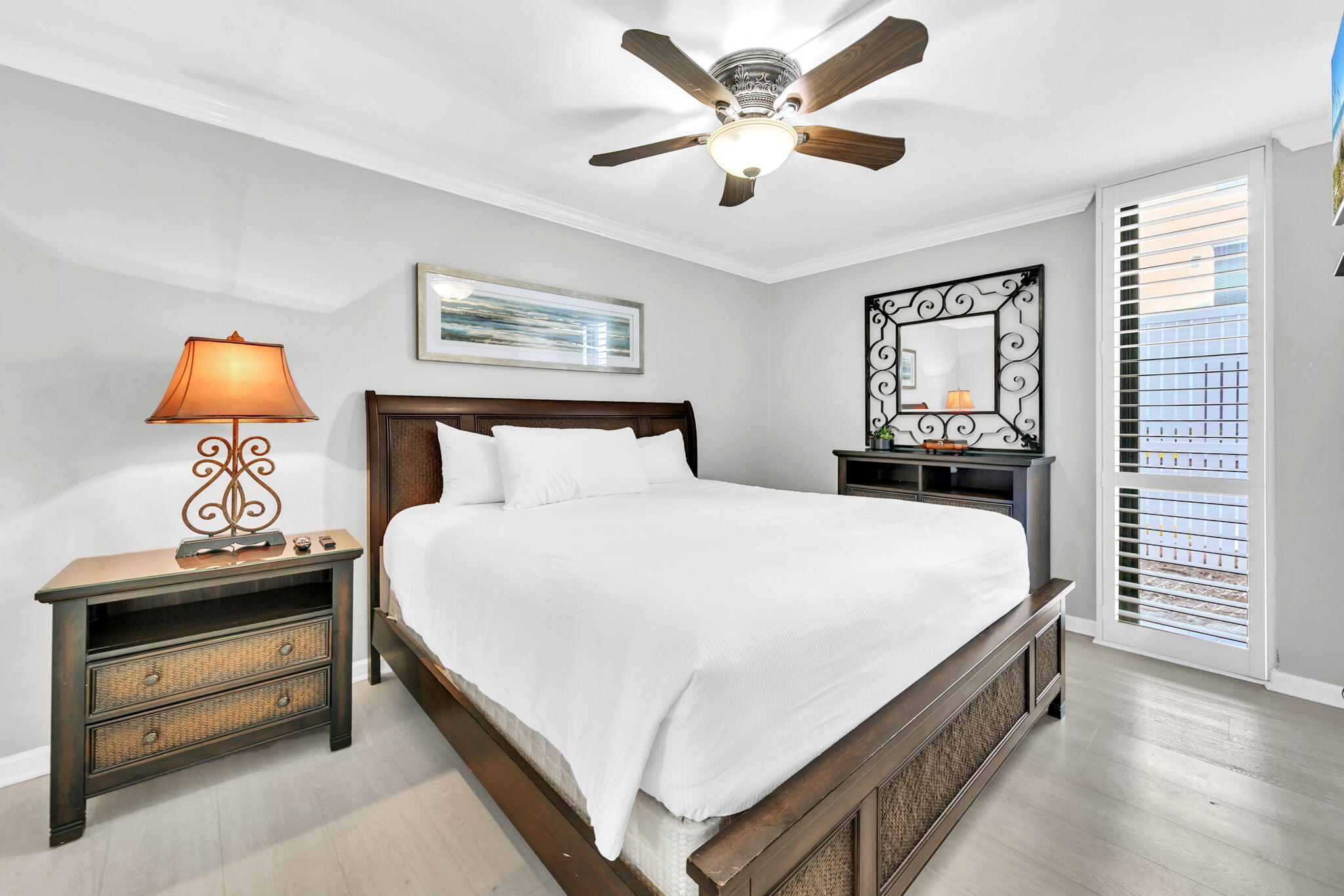 1044 Highway 98, Unit 101 Destin, FL 32541 - Photo 12 of 33 a bedroom with a bed and a chandelier