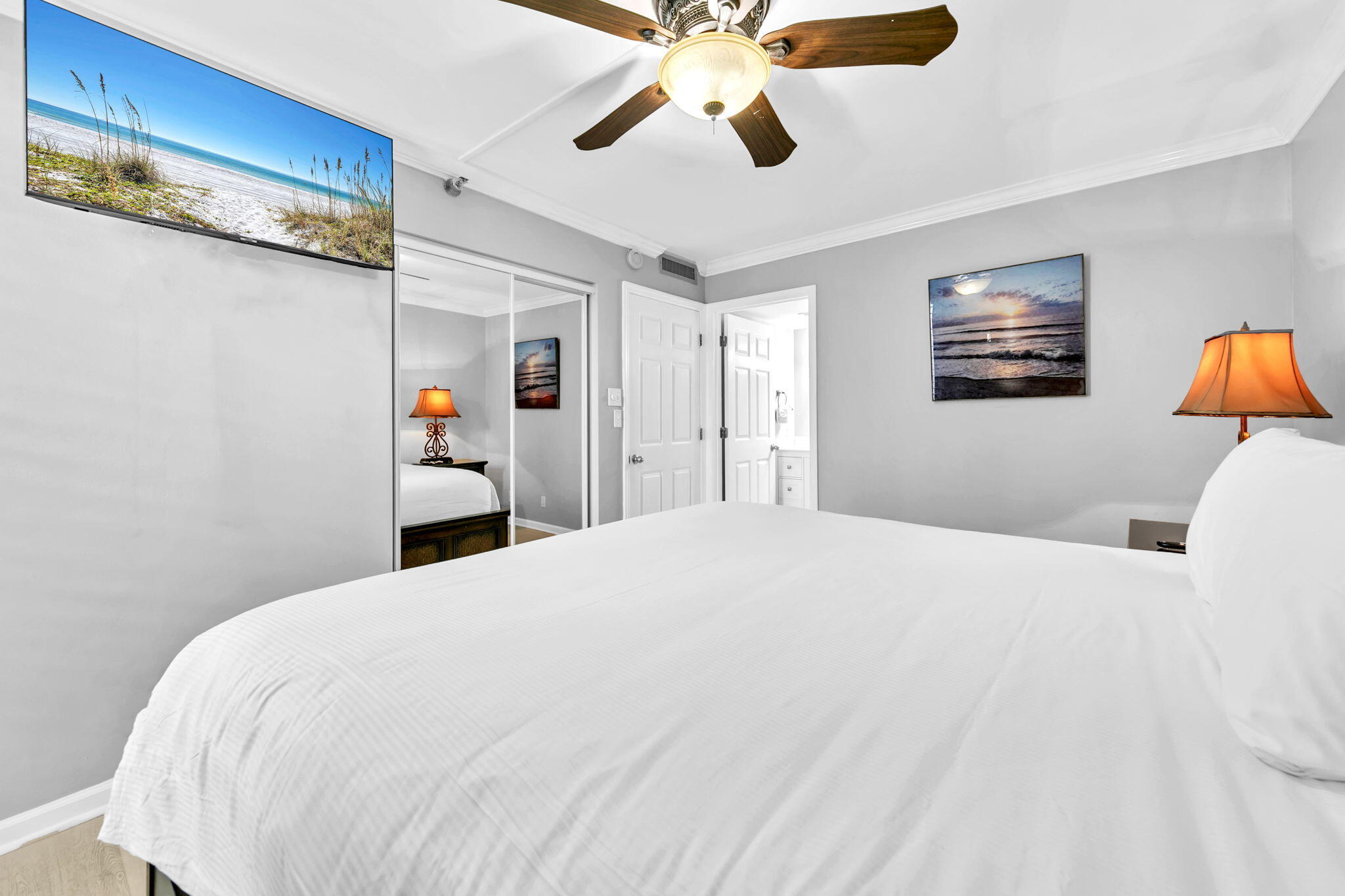 1044 Highway 98, Unit 101 Destin, FL 32541 - Photo 13 of 33 a bedroom with a bed and a ceiling fan