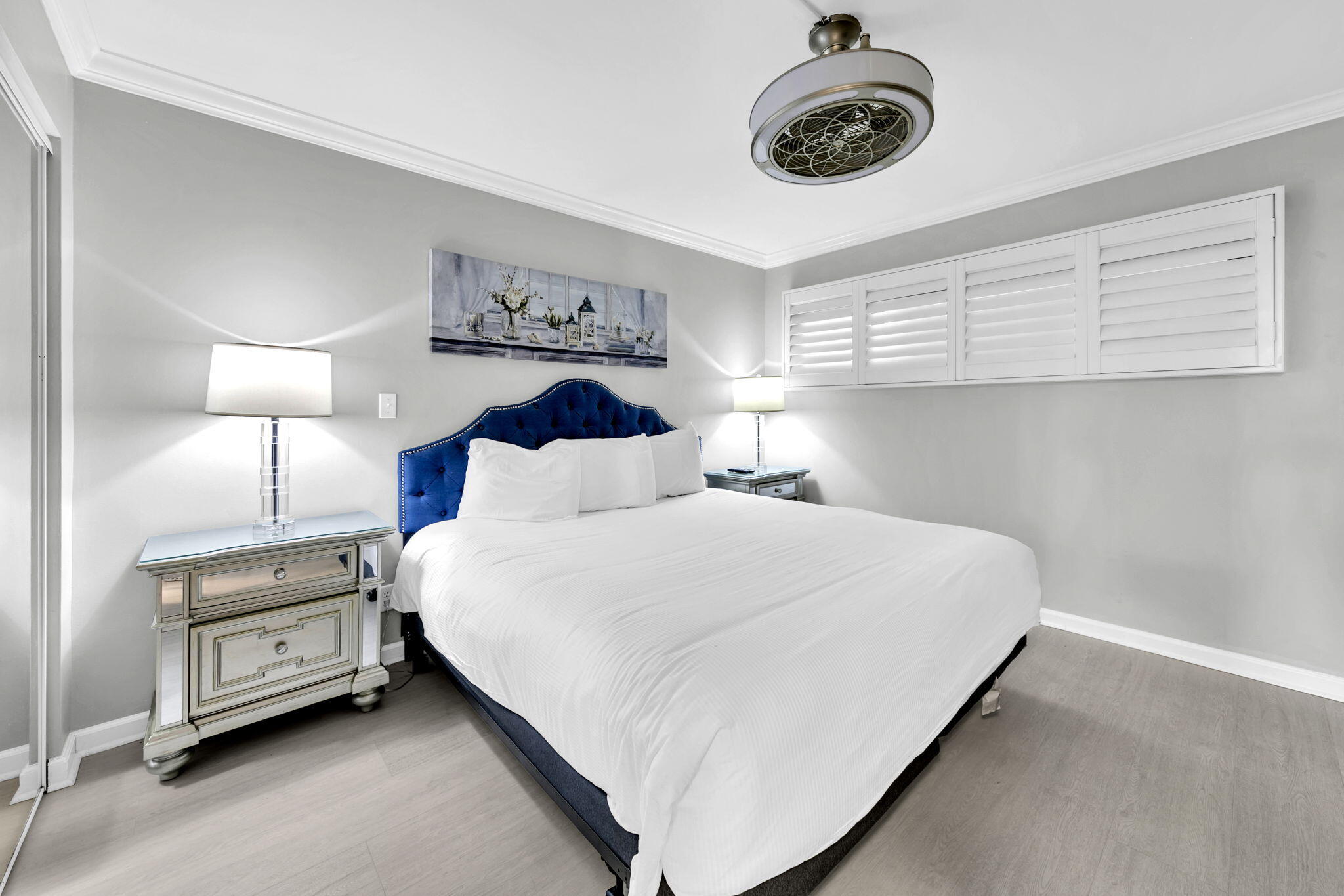1044 Highway 98, Unit 101 Destin, FL 32541 - Photo 16 of 33 a bedroom with a bed and a chandelier