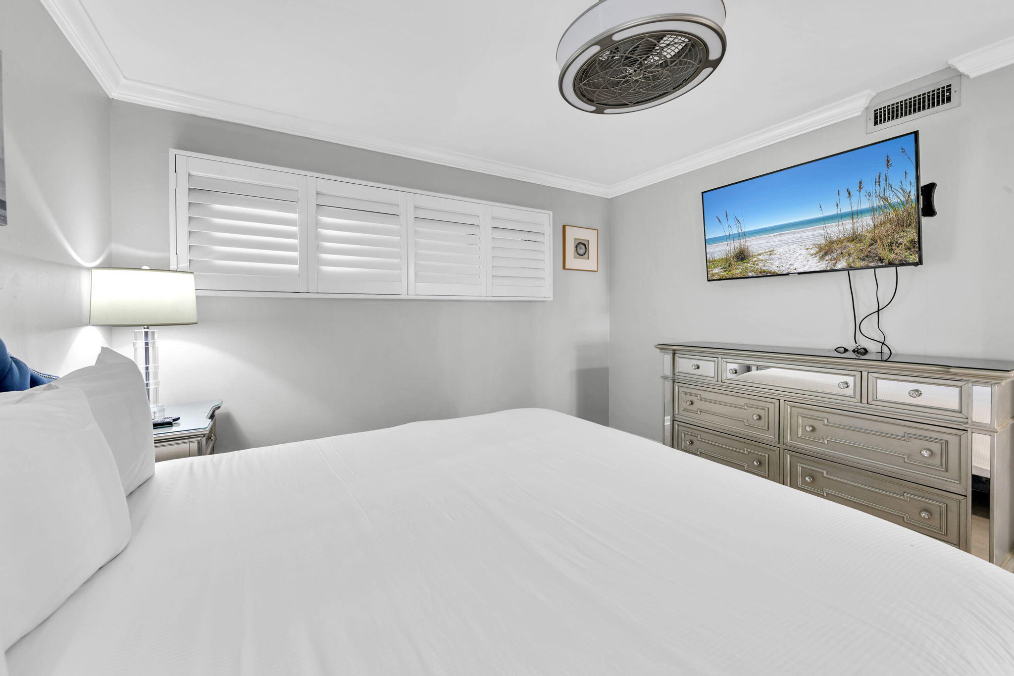 1044 Highway 98, Unit 101 Destin, FL 32541 - Photo 17 of 33 a bedroom with a bed and a chandelier