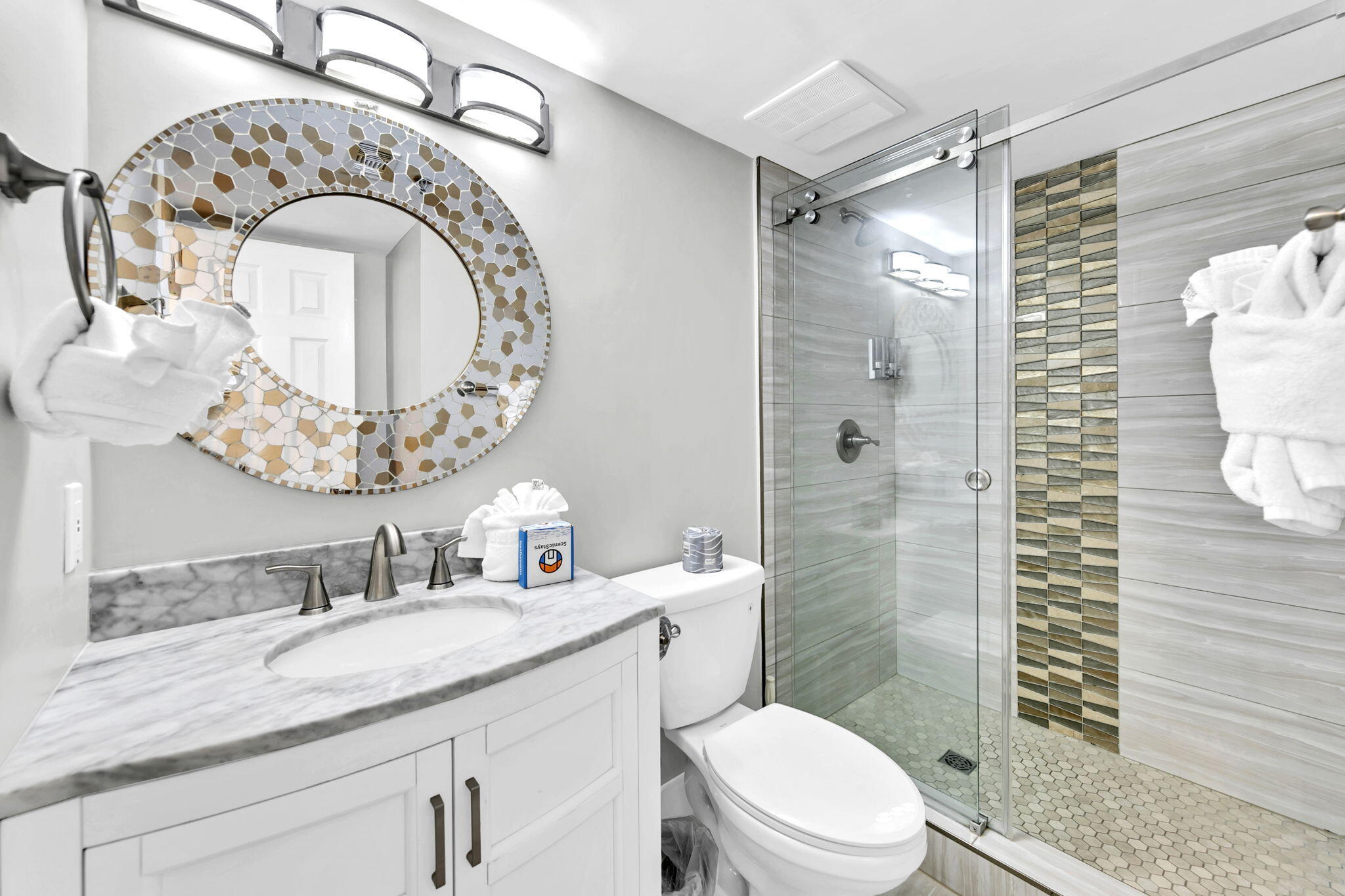 1044 Highway 98, Unit 101 Destin, FL 32541 - Photo 18 of 33 a bathroom with a granite countertop toilet sink and mirror