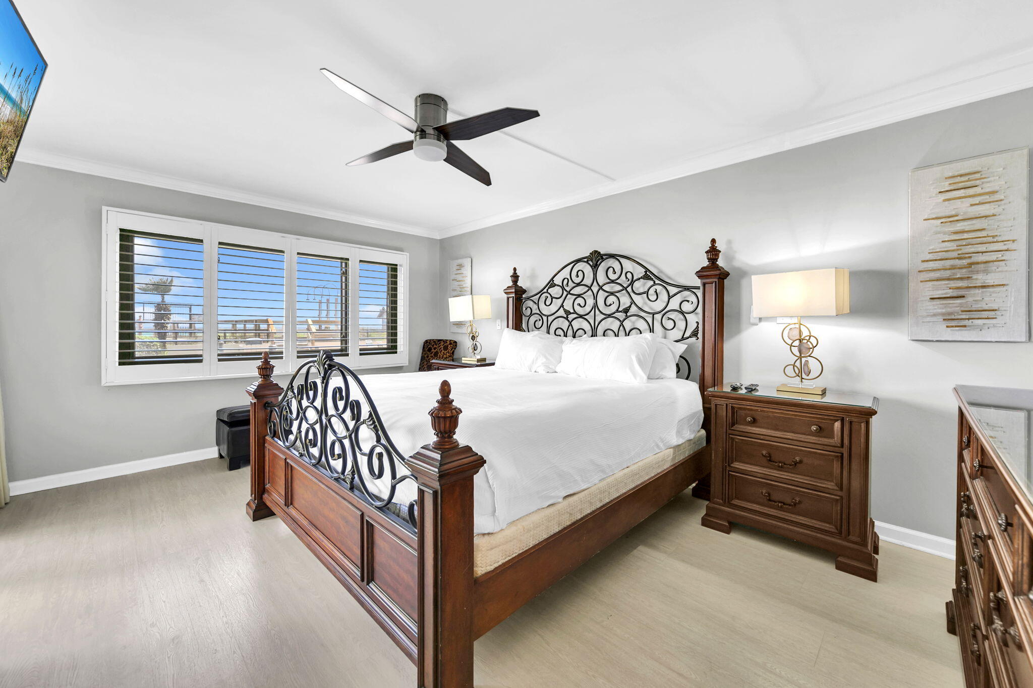 1044 Highway 98, Unit 101 Destin, FL 32541 - Photo 20 of 33 a bedroom with a bed next to a window with a chandelier