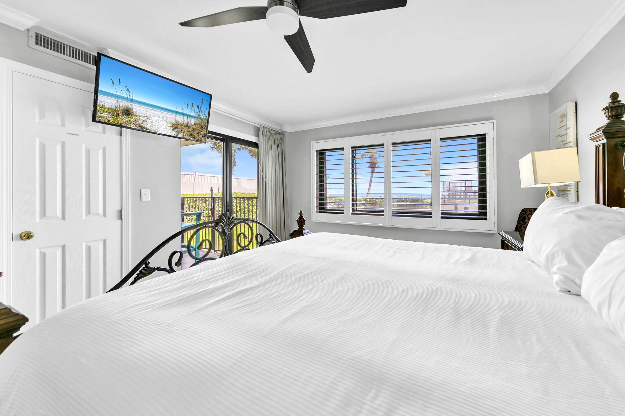 1044 Highway 98, Unit 101 Destin, FL 32541 - Photo 21 of 33 a bedroom with a bed next to a window and a chandelier