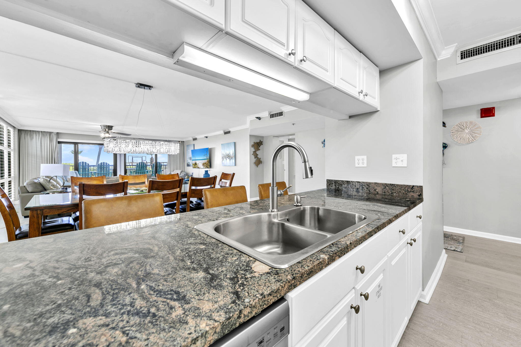 1044 Highway 98, Unit 101 Destin, FL 32541 - Photo 7 of 33 a kitchen with stainless steel appliances granite countertop a sink and white cabinets