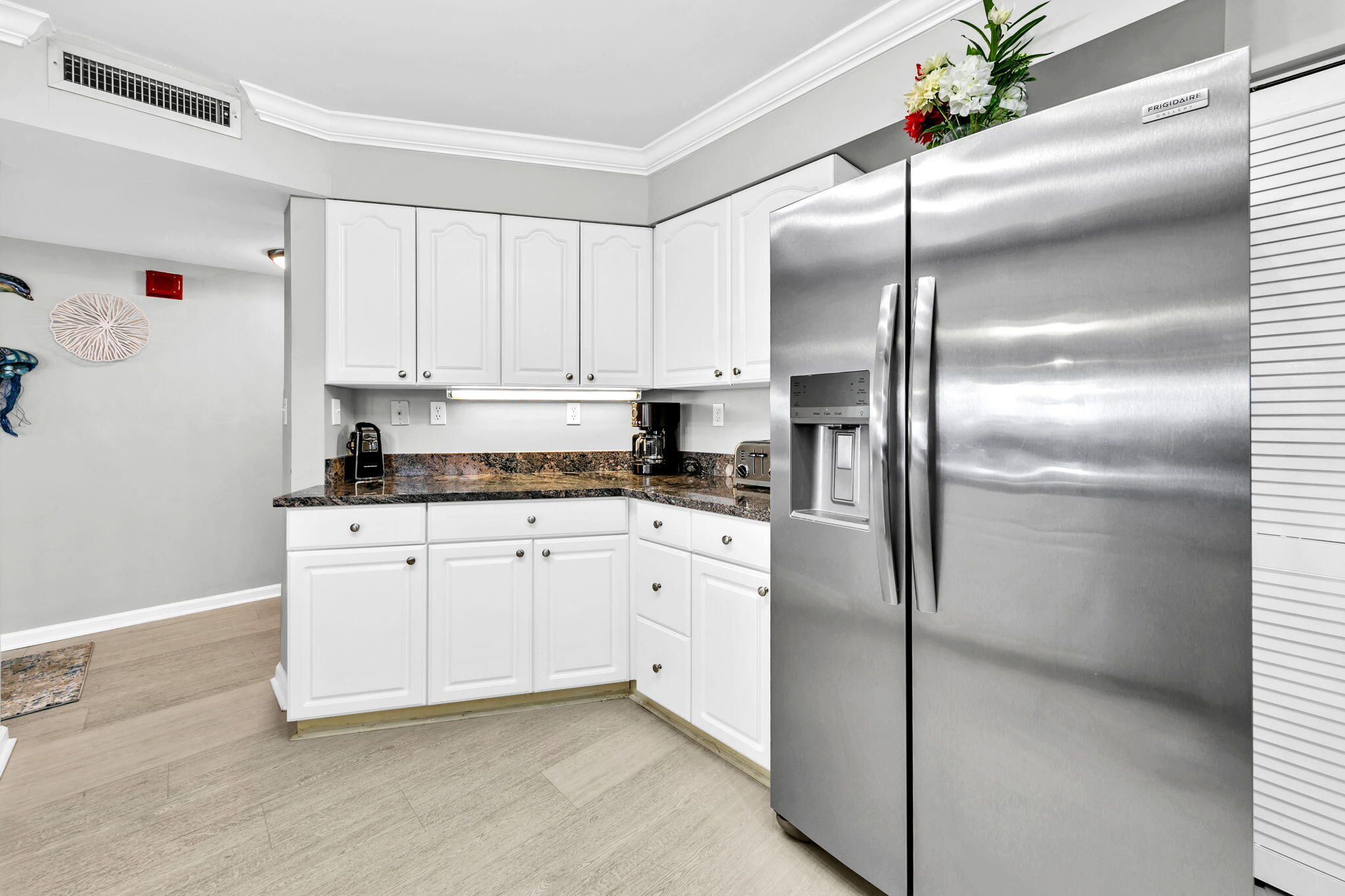 1044 Highway 98, Unit 101 Destin, FL 32541 - Photo 10 of 33 a kitchen with cabinets and stainless steel appliances