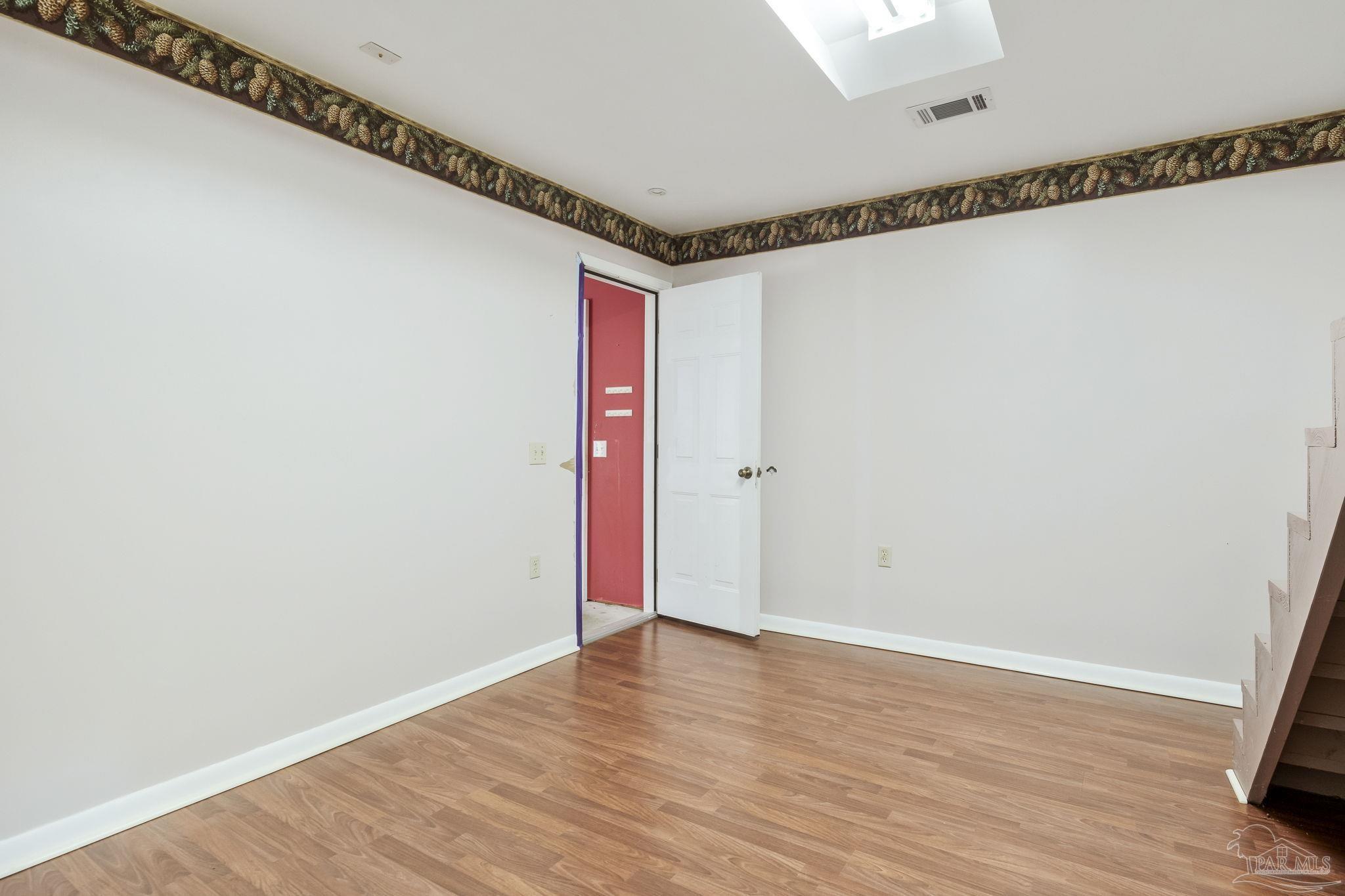 4411 Pace Lane Pace, FL 32571 - Photo 27 of 68 a view of a room with wooden floor and white walls