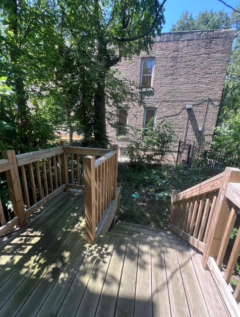 6756 South Lafayette Avenue Chicago, IL 60621 - Photo 16 of 16 a view of balcony with wooden floor and fence