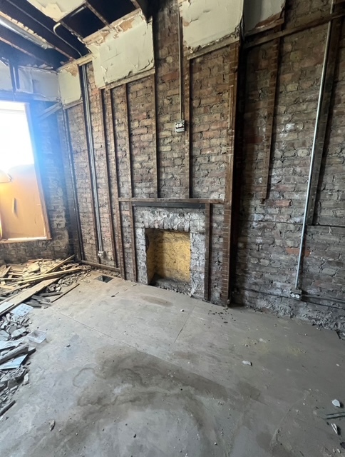 6756 South Lafayette Avenue Chicago, IL 60621 - Photo 4 of 16 a view of an empty room with a fireplace