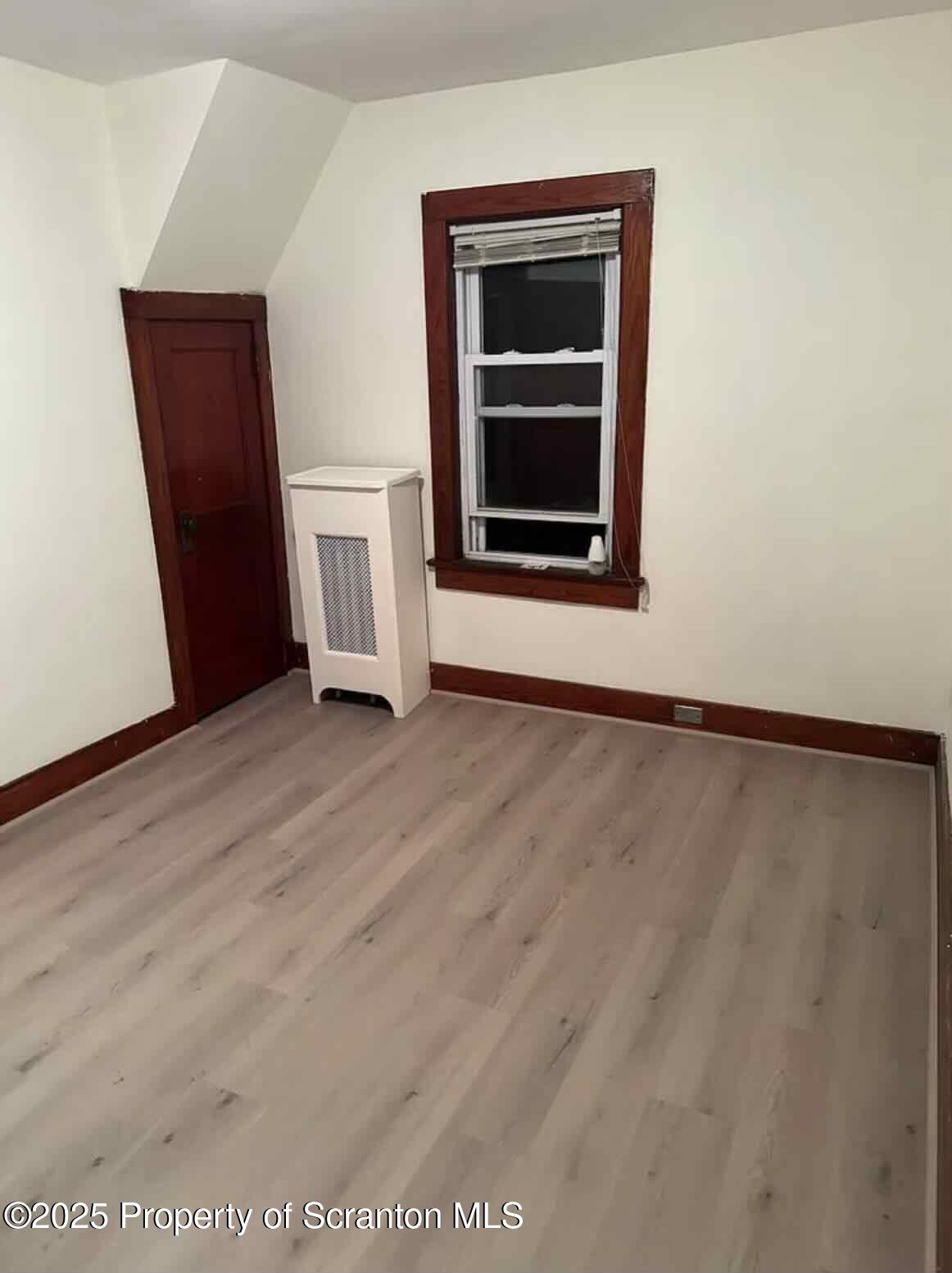 1116 Fairfield Street Scranton, PA 18509 - Photo 11 of 11 a view of an empty room with wooden floor and a window