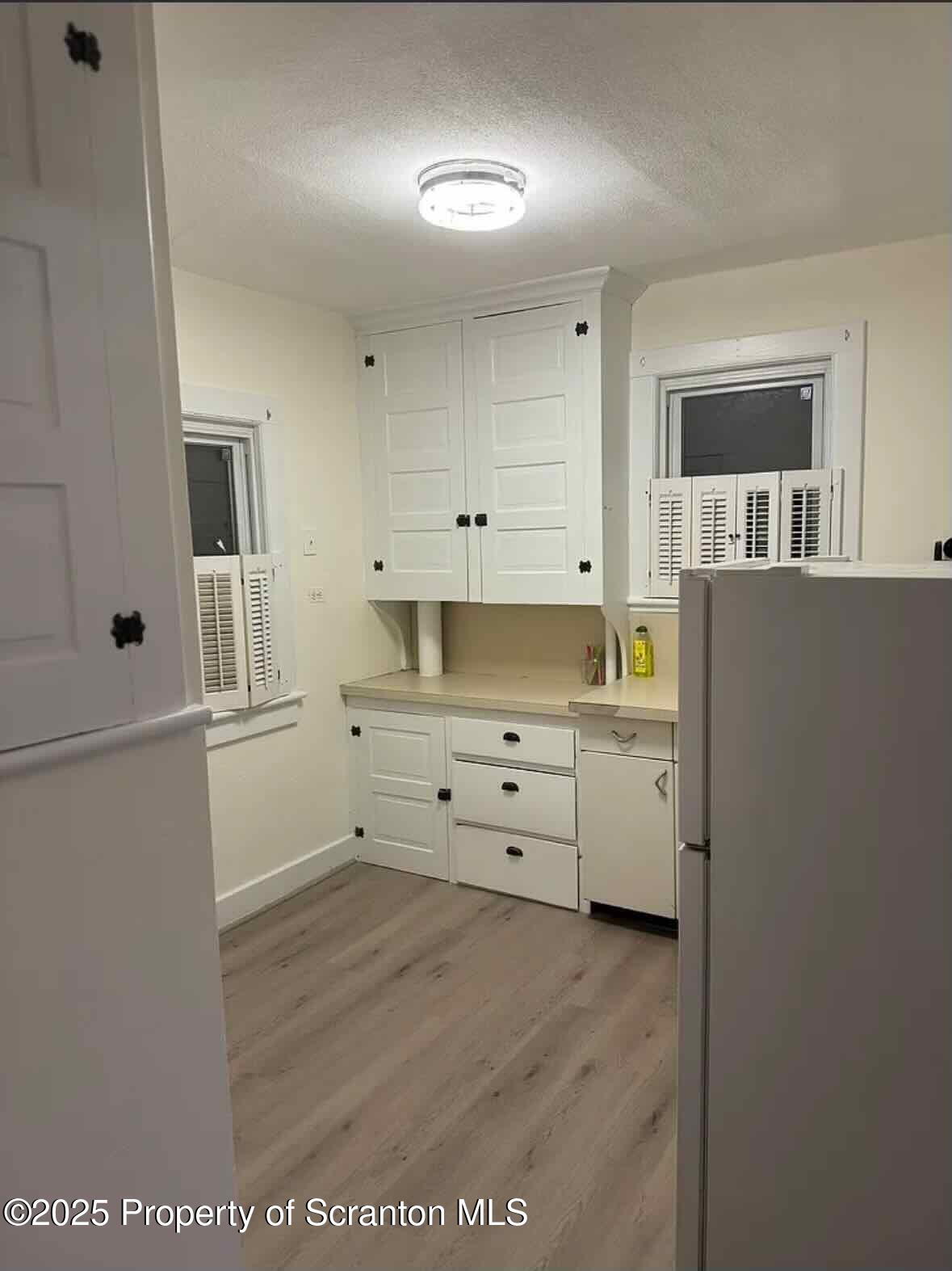 1116 Fairfield Street Scranton, PA 18509 - Photo 2 of 11 a kitchen with cabinets appliances and a wooden floor