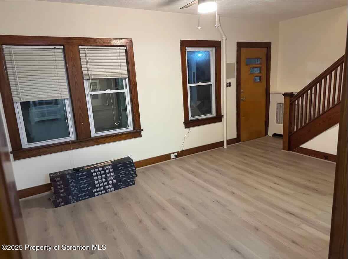 1116 Fairfield Street Scranton, PA 18509 - Photo 3 of 11 a view of an empty room with wooden floor and a window
