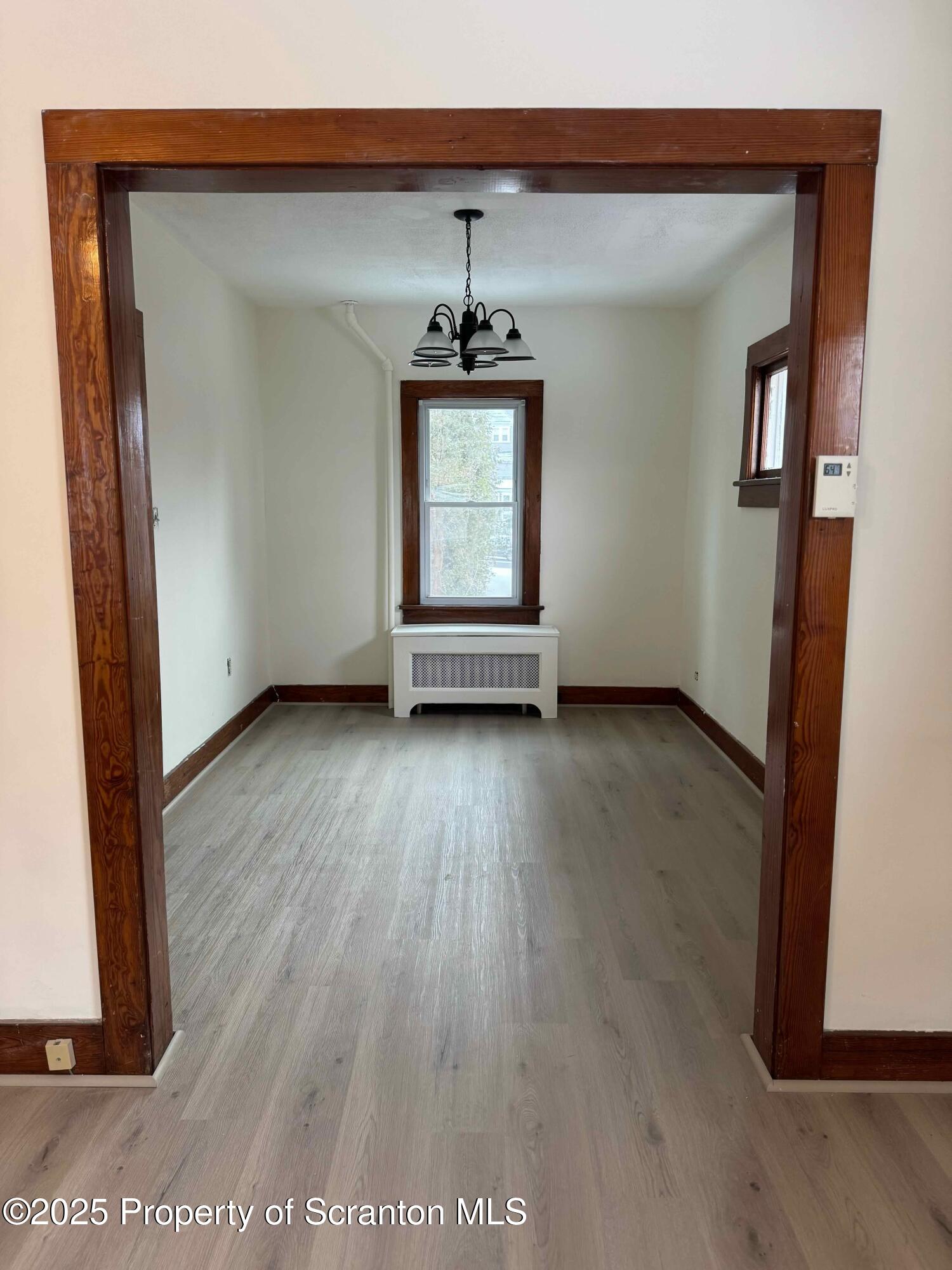 1116 Fairfield Street Scranton, PA 18509 - Photo 5 of 11 an empty room with wooden floor and windows