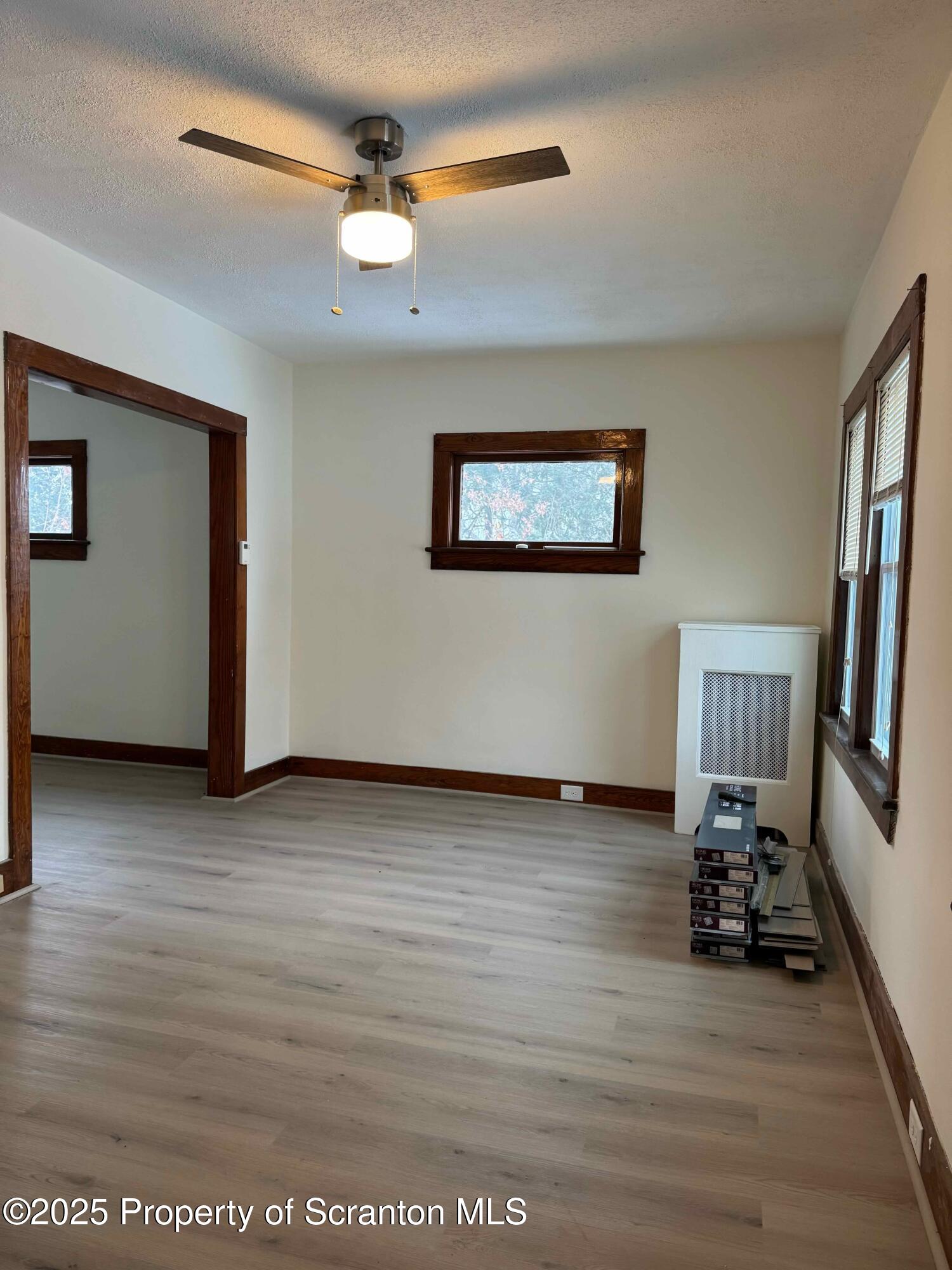 1116 Fairfield Street Scranton, PA 18509 - Photo 6 of 11 a view of a livingroom with hardwood floor and a ceiling fan
