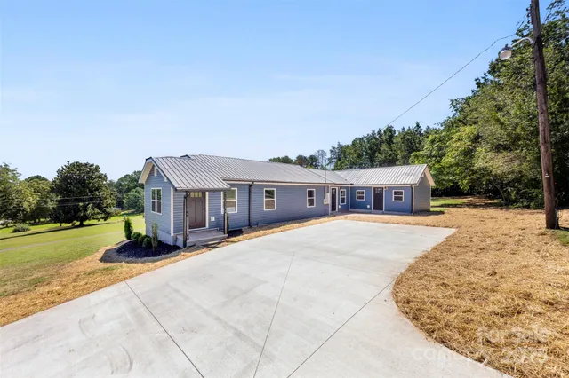 a house view with a sitting space and garden