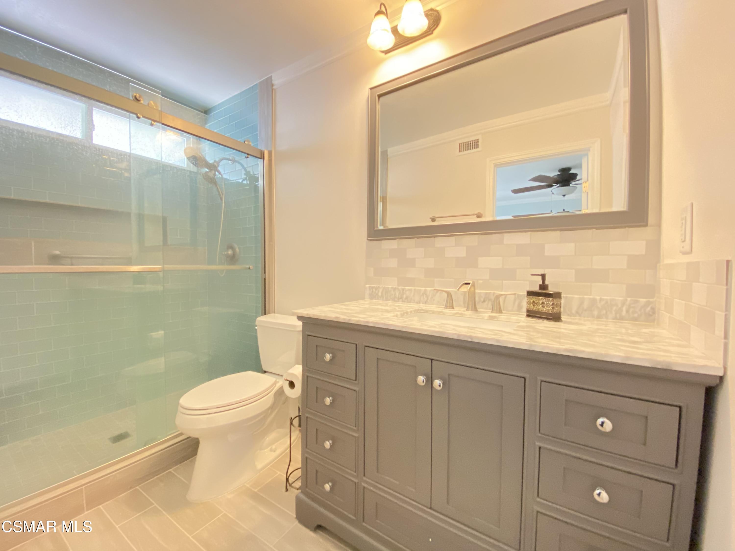2170 Burrell Avenue Simi Valley, CA 93063 - Photo 17 of 21 a bathroom with a granite countertop sink toilet and shower