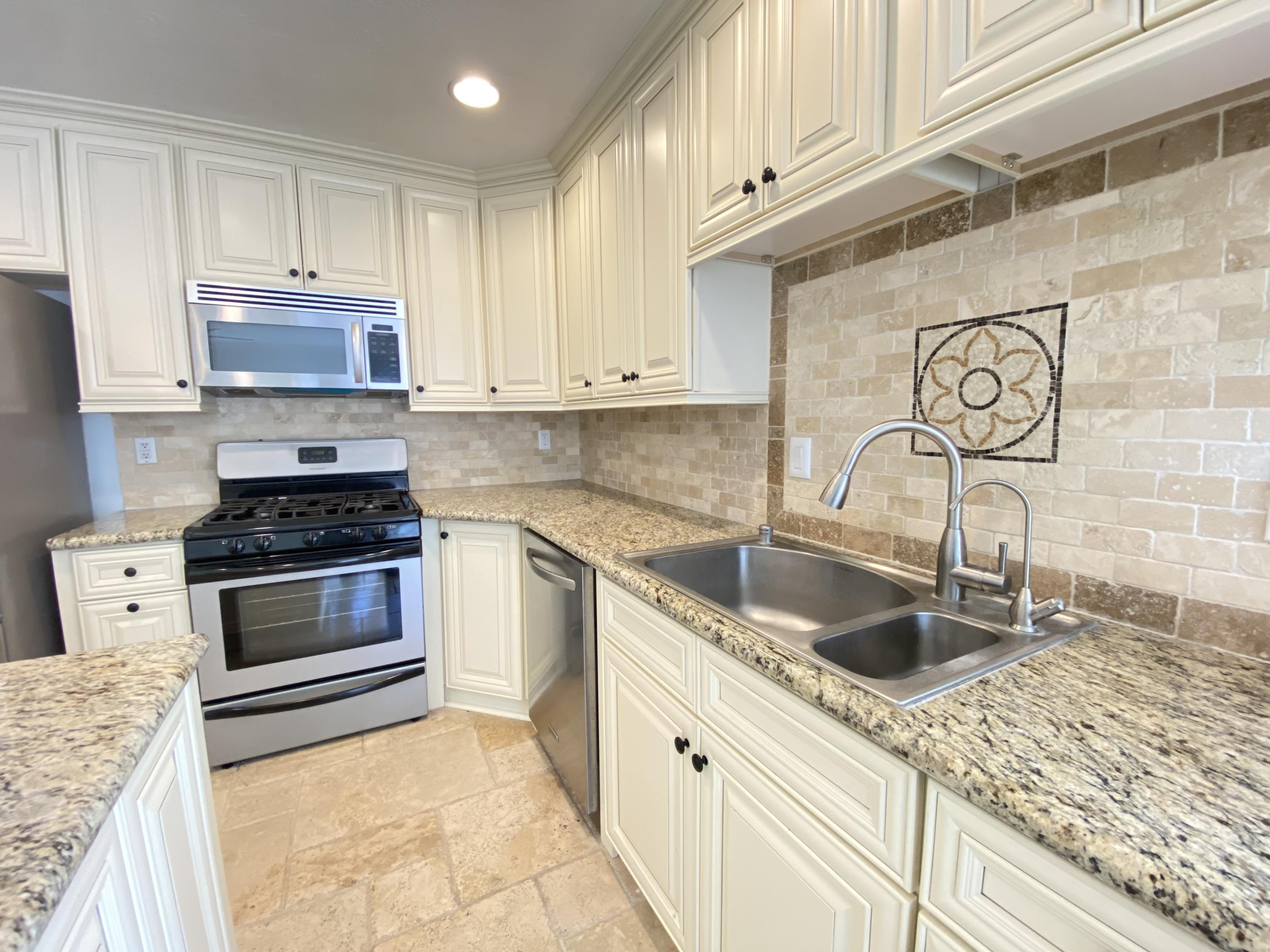 2170 Burrell Avenue Simi Valley, CA 93063 - Photo 9 of 21 a kitchen with granite countertop a stove sink and cabinets
