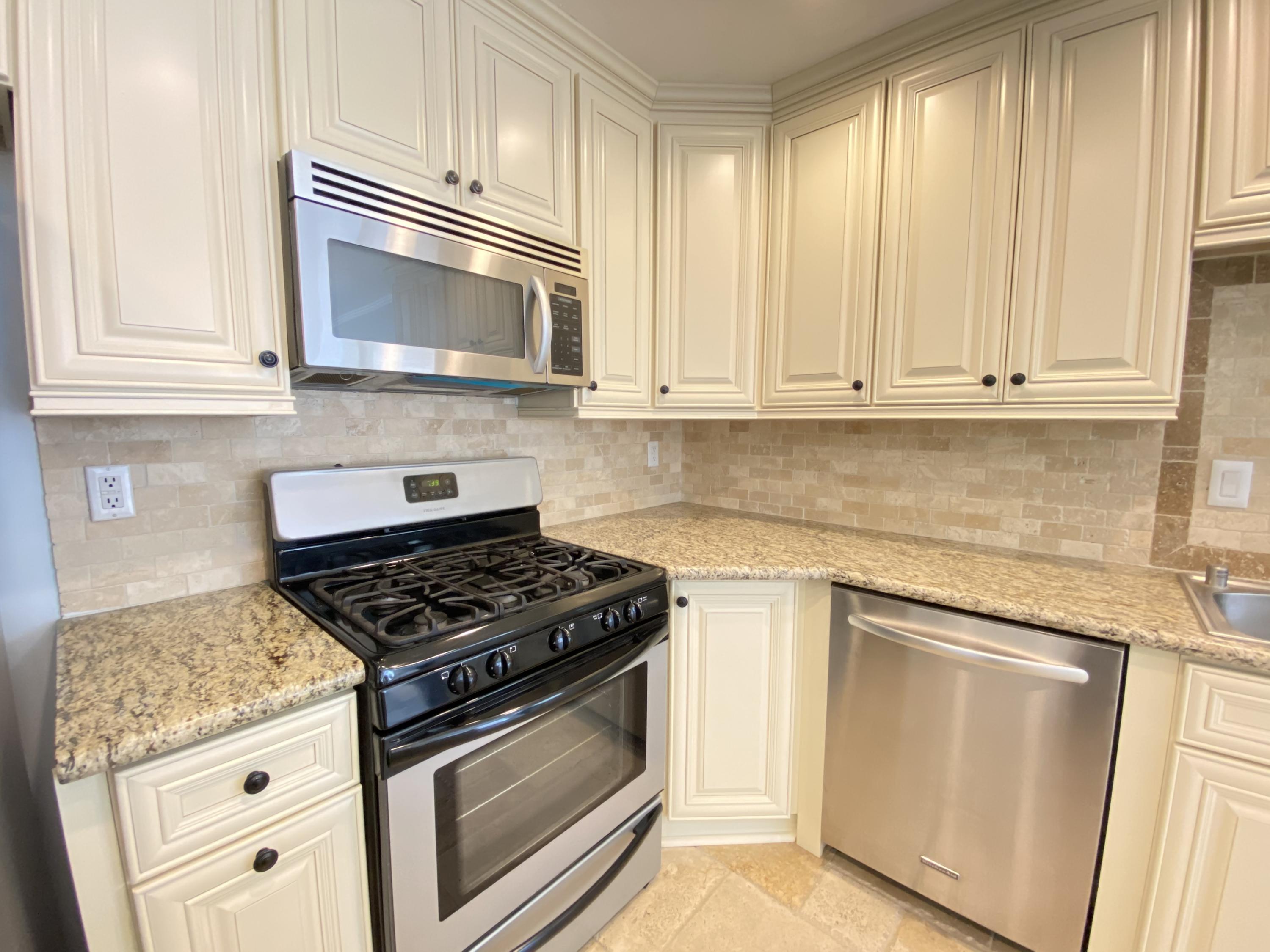 2170 Burrell Avenue Simi Valley, CA 93063 - Photo 10 of 21 a kitchen with granite countertop white cabinets and appliances