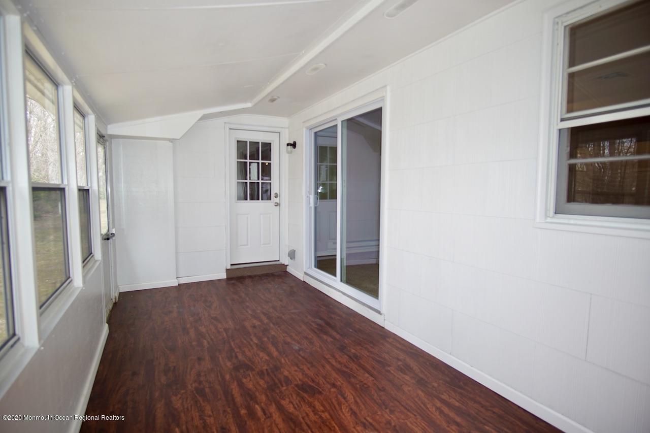 49 Markham Road Brick, NJ 08724 - Photo 6 of 13 an empty room with wooden floor and windows