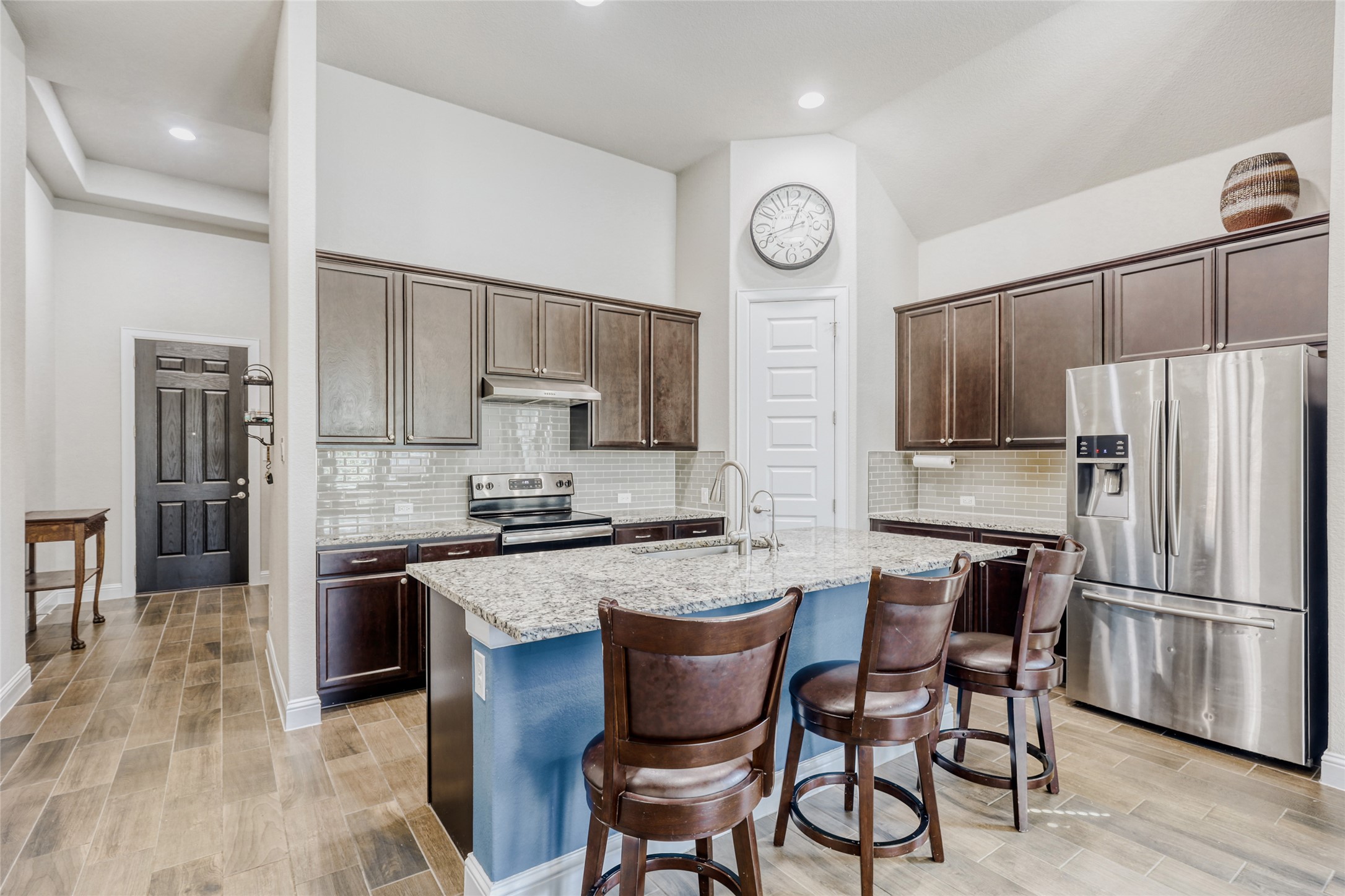 125 Buffalo View Lane Georgetown, TX 78628 - Photo 6 of 28 a kitchen with stainless steel appliances granite countertop a stove top oven a refrigerator a sink and chairs