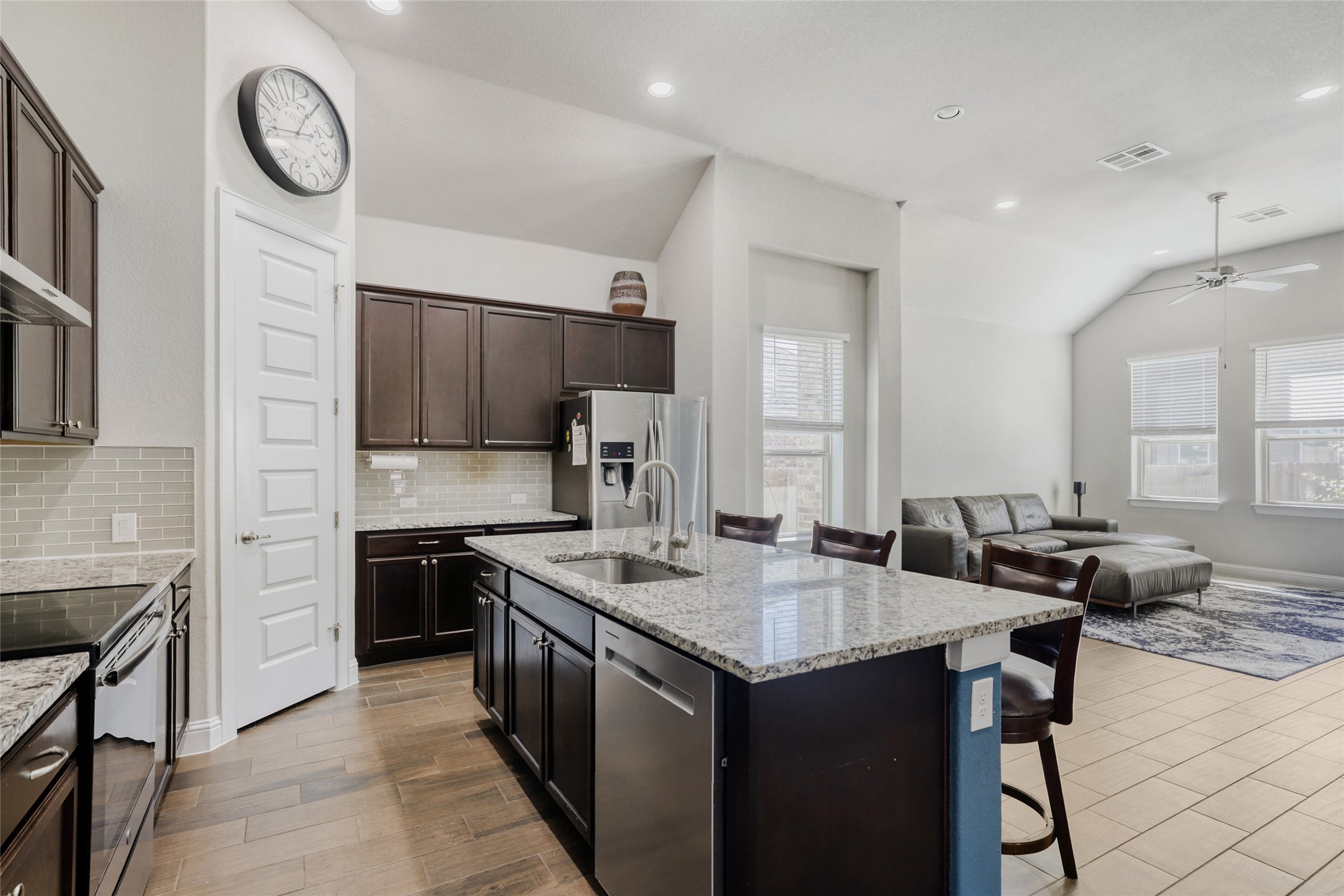 125 Buffalo View Lane Georgetown, TX 78628 - Photo 8 of 28 a kitchen with granite countertop a sink a stove top oven a refrigerator a counter top space and cabinets