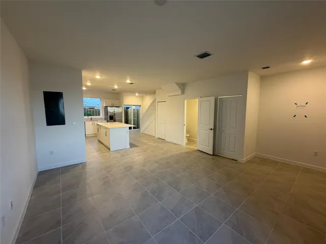 a view of a livingroom with kitchen and furniture