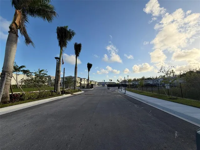 a view of a street with a building in the background