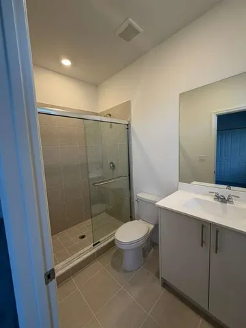 a bathroom with a shower toilet and sink