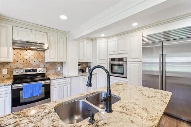 a spacious bedroom with a bed and a chandelier