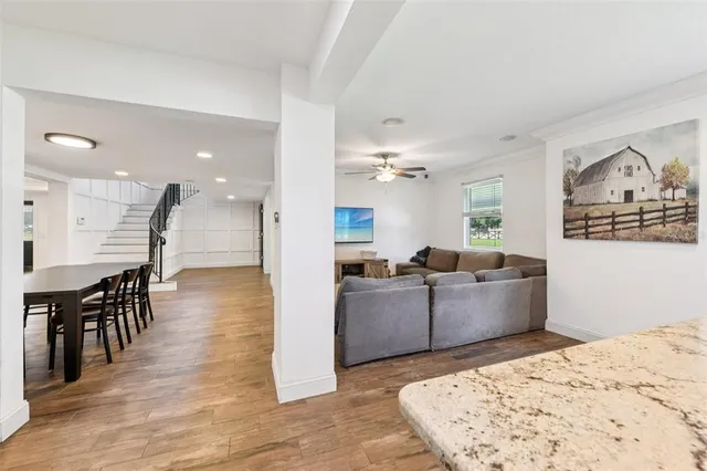 a bathroom with a granite countertop toilet sink and mirror