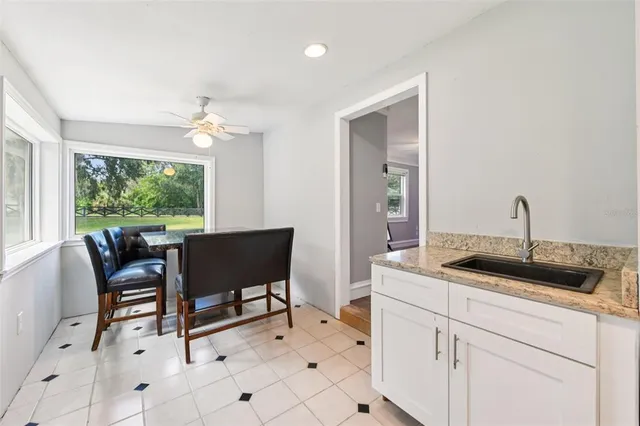 a spacious bedroom with a bed a couch and a chandelier