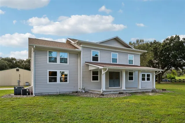 a front view of a house with a garden and yard